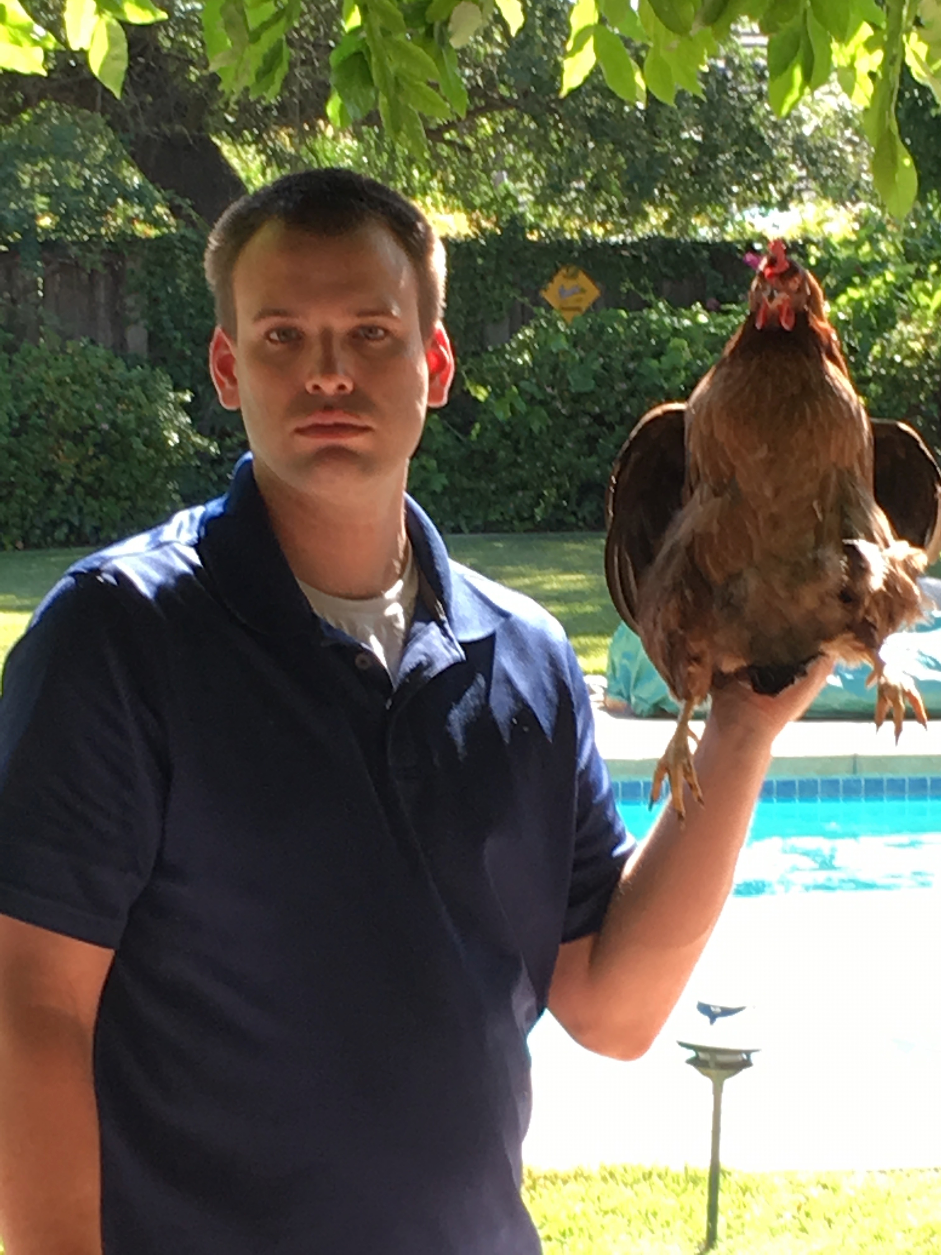 Picture of Steven holding one of our chickens
